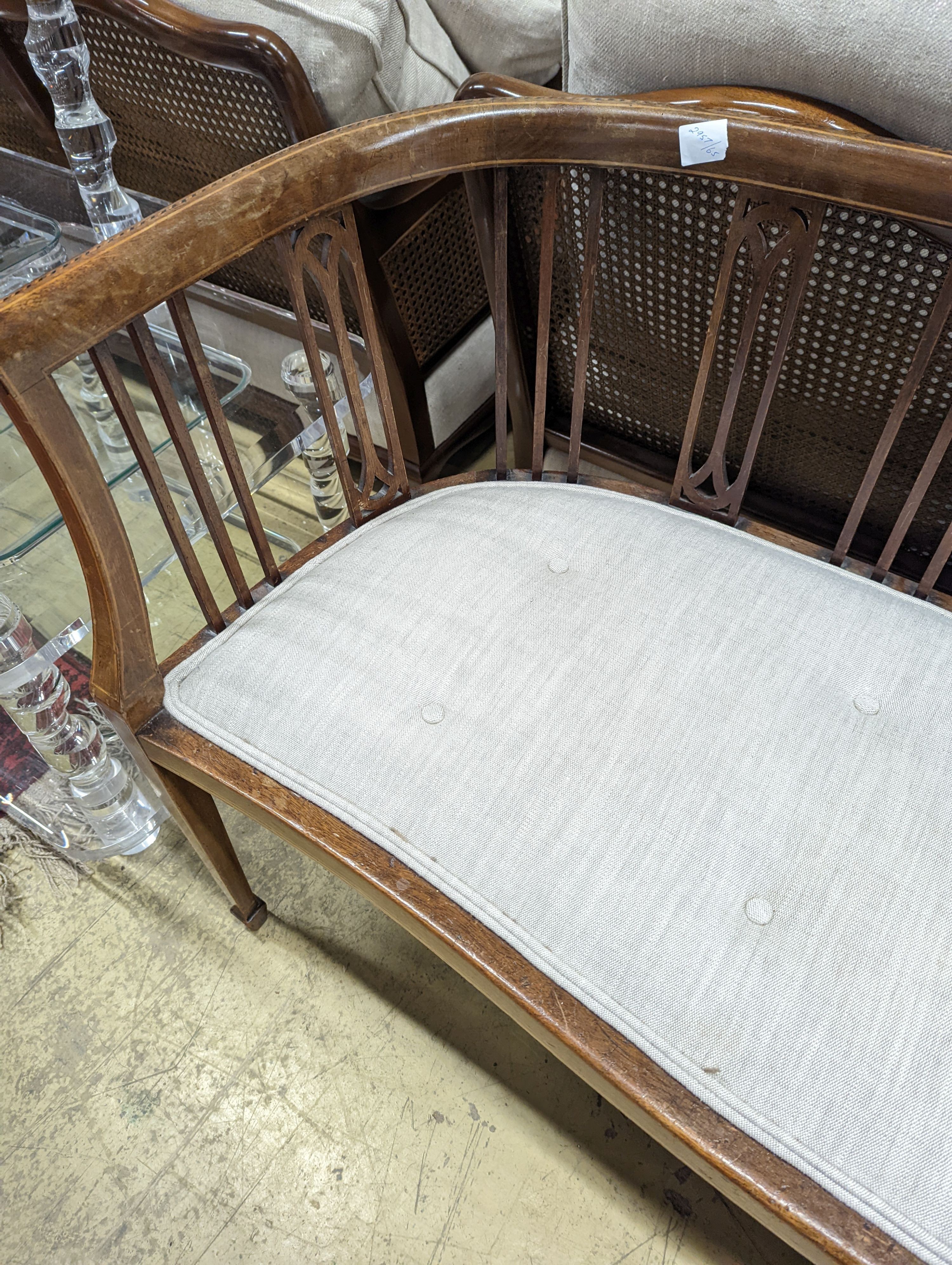 An Edwardian inlaid mahogany slat back settee, length 164cm, depth 47cm, height 74cm